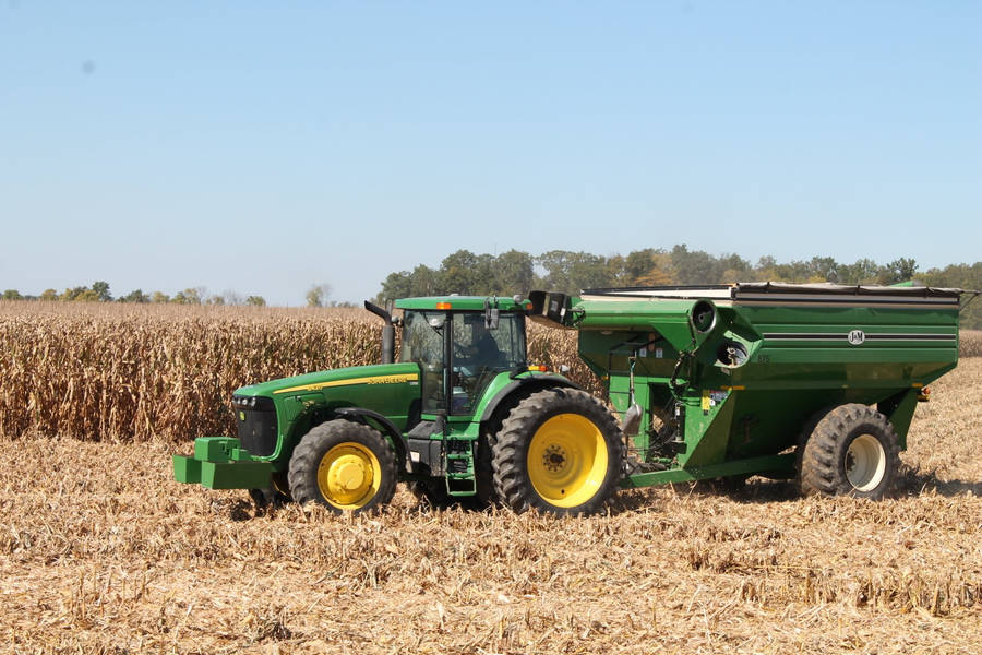 John Deere Tractor In Harvesting Wheat Wallpaper