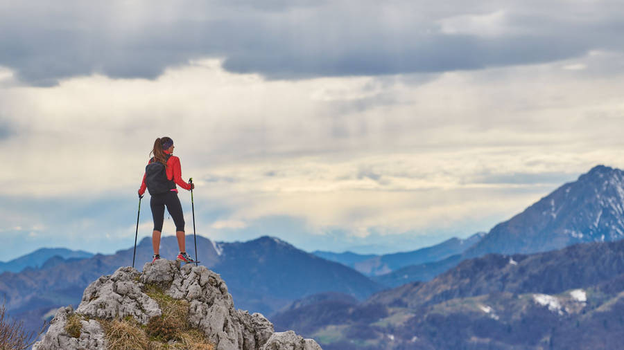 Journey Of Woman Standing On Rock Wallpaper