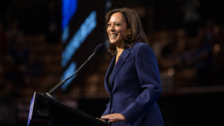 Kamala Harris Smile Onstage Wallpaper