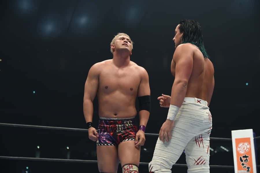 Kazuchika Okada Facing Off Jay White In An Intense Wrestling Match Wallpaper