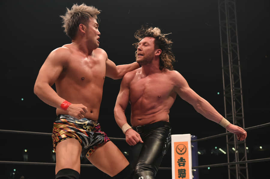 Kazuchika Okada Punching Kenny Omega Wallpaper