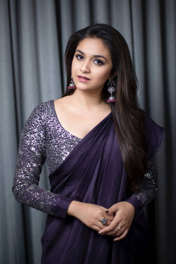 Keerthi Suresh Radiating Elegance In Dark Violet Outfit Wallpaper