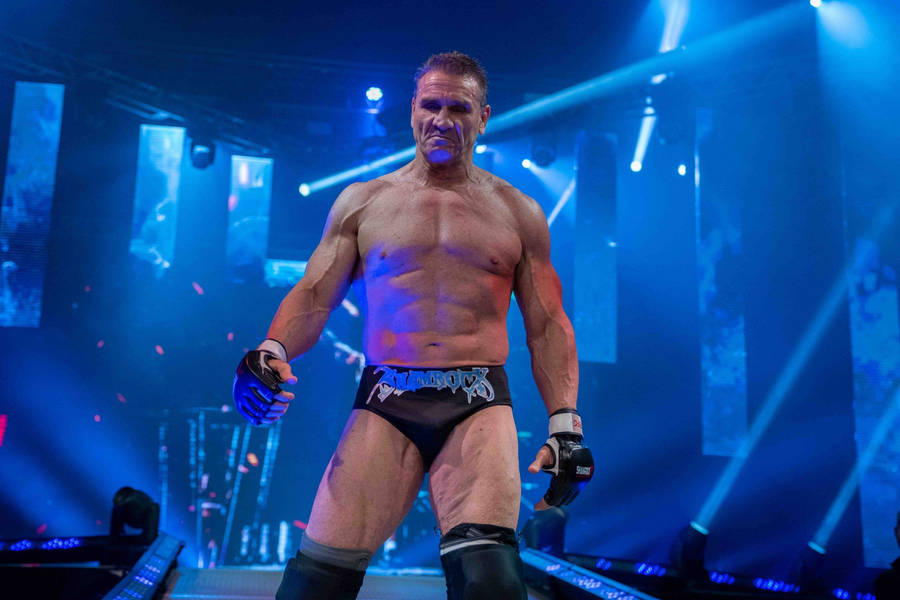 Ken Shamrock Surrounded By Blue Lights Wallpaper