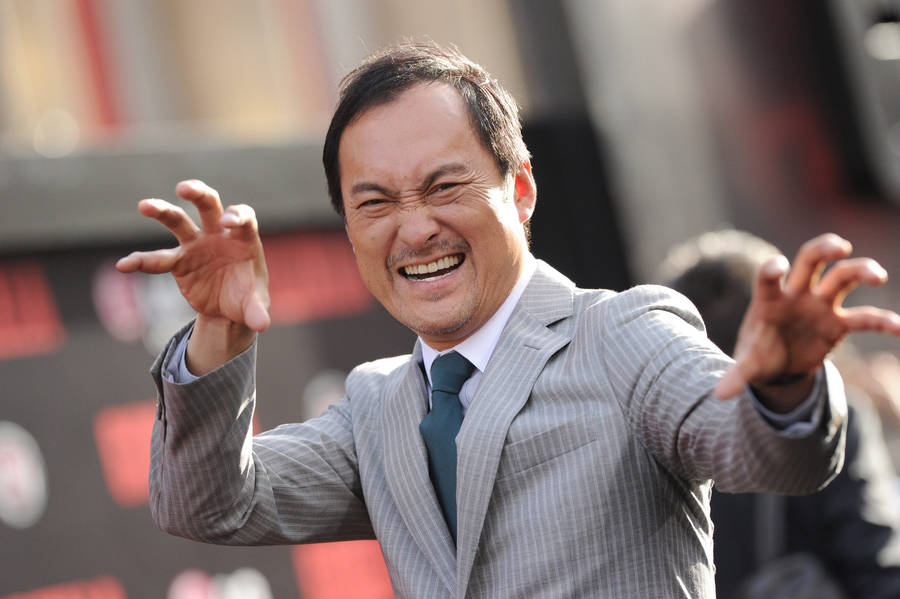 Ken Watanabe Exhibiting A Funny Pose On The Red Carpet Wallpaper