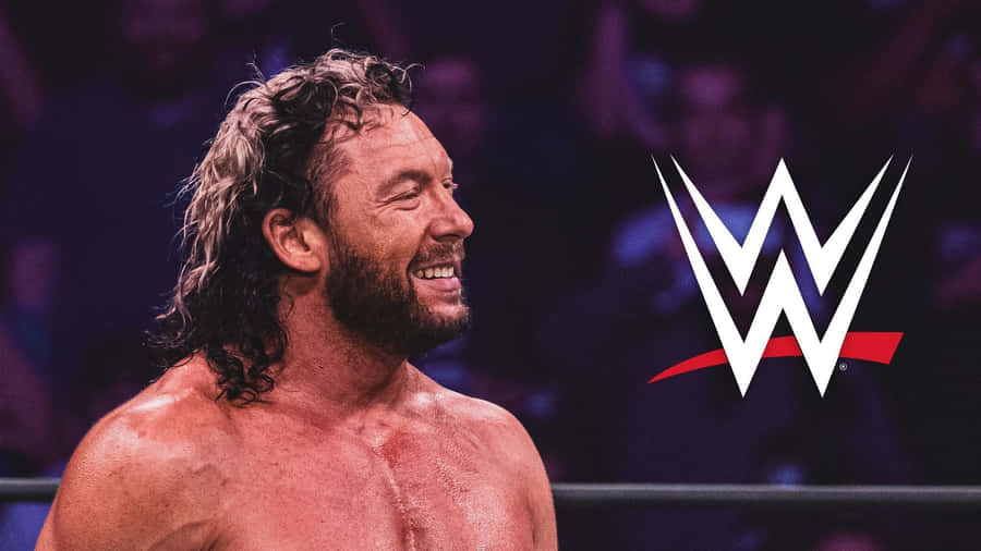 Kenny Omega Beside The Wwe Logo Wallpaper