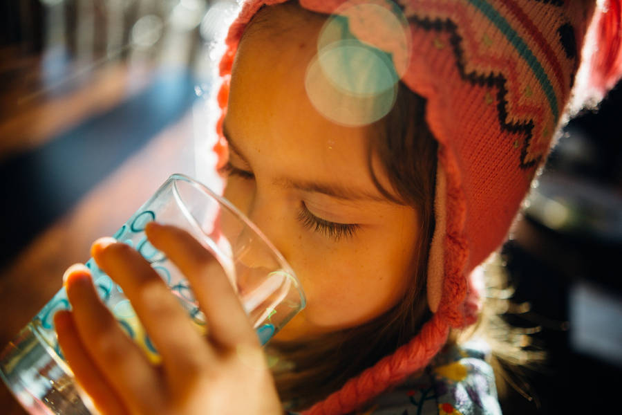 Kid With Hat Drinking Water Wallpaper