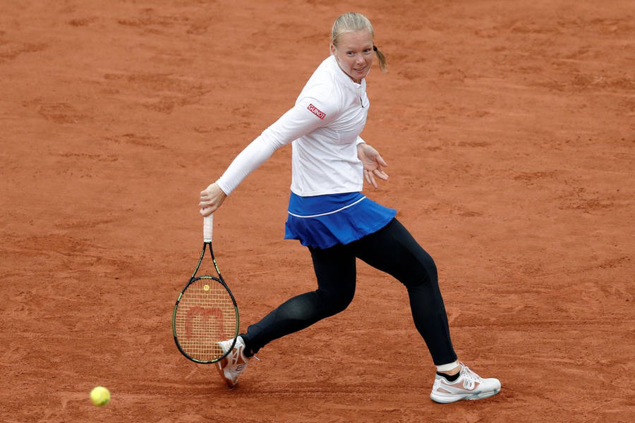 Kiki Bertens Demonstrating Her Power And Skill On A Clay Court Wallpaper