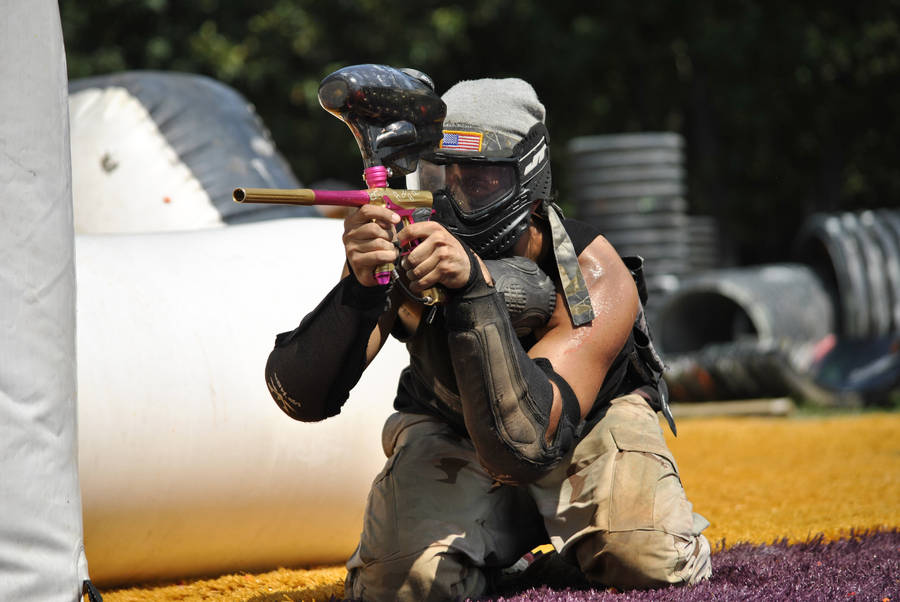 Kneeling Paintball Player Taking Aim Wallpaper