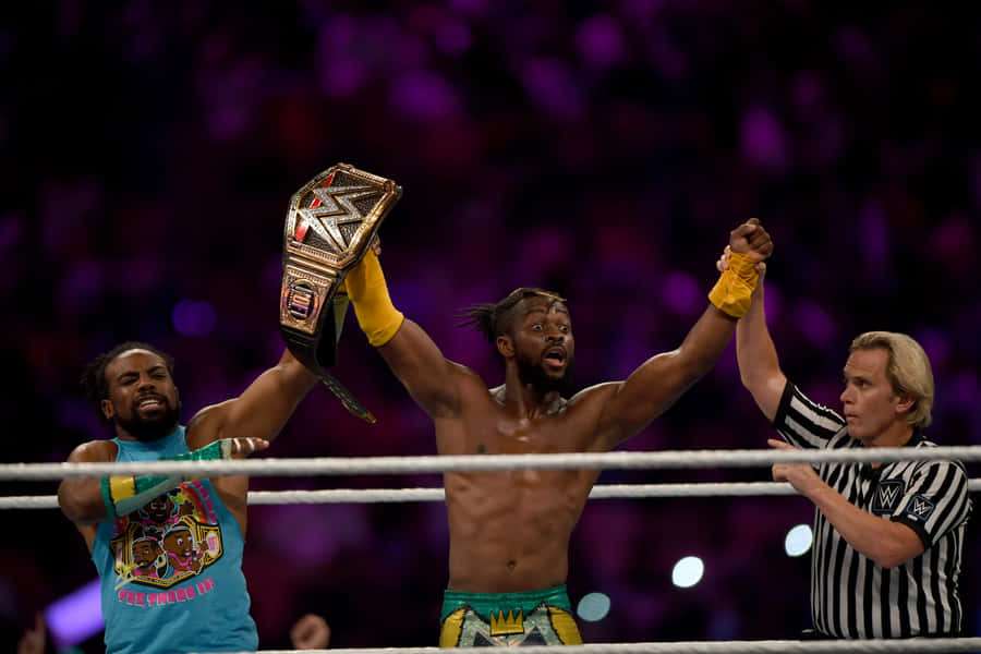 Kofi Kingston Holding The Wwe Championship Belt Wallpaper