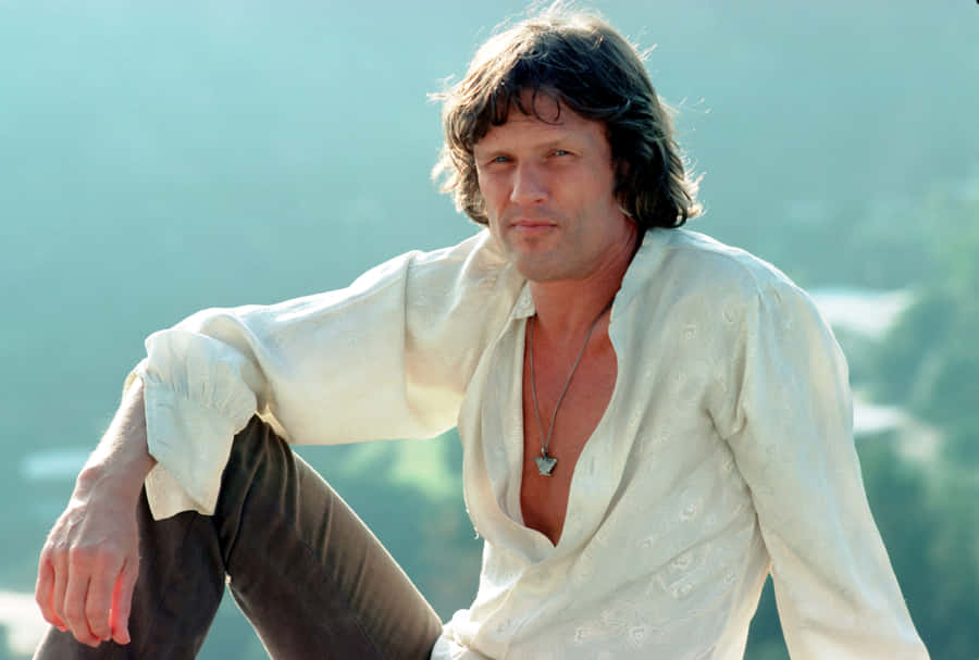 Kris Kristofferson Relaxed Pose Outdoors Wallpaper