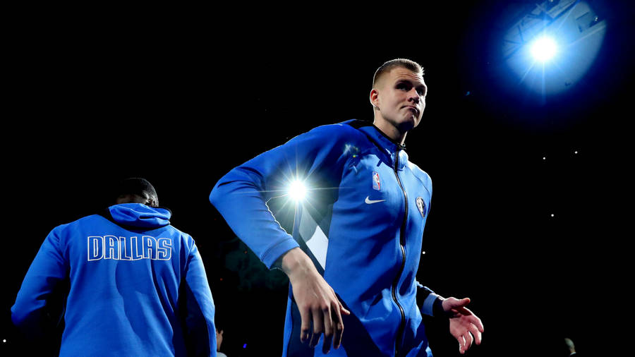 Kristaps Porzingis In Action On The Dallas Mavericks Basketball Court Wallpaper