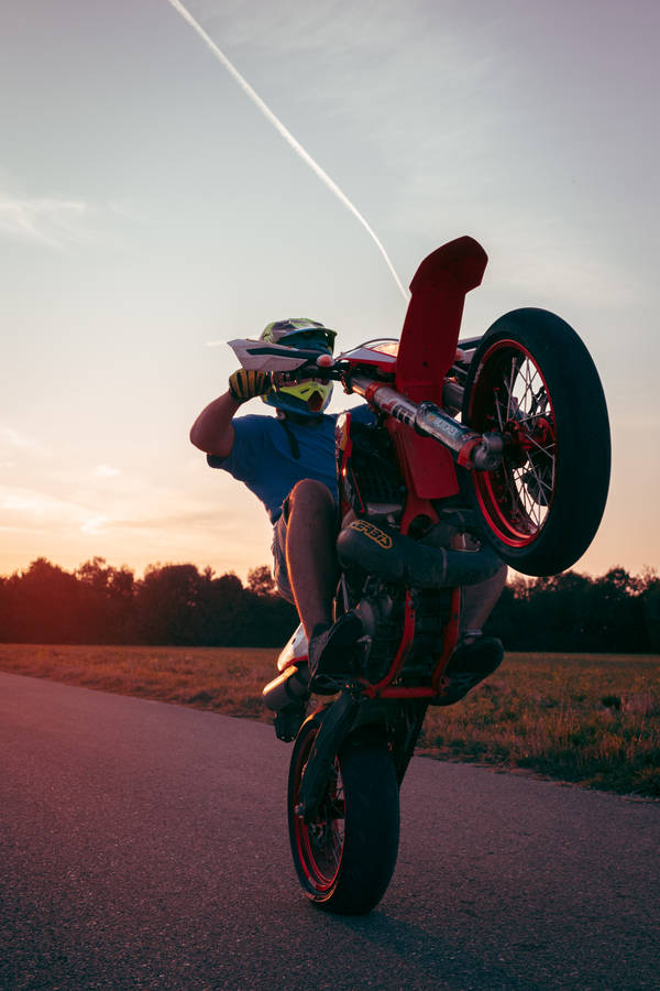 Ktm Biker During Wheelie Wallpaper