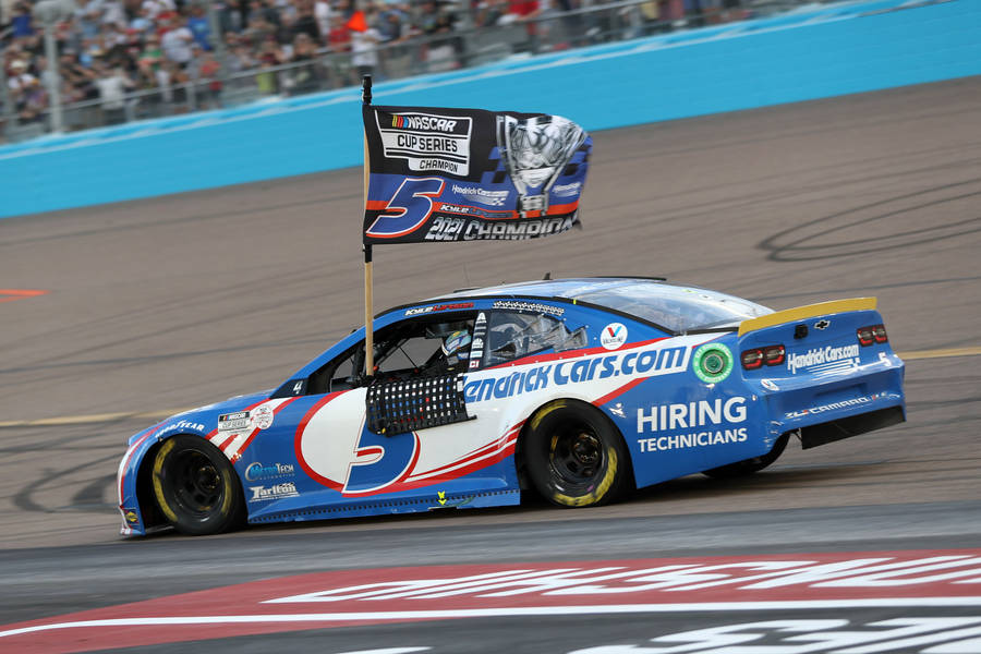 Kyle Larson’s Blue Car And Flag Wallpaper