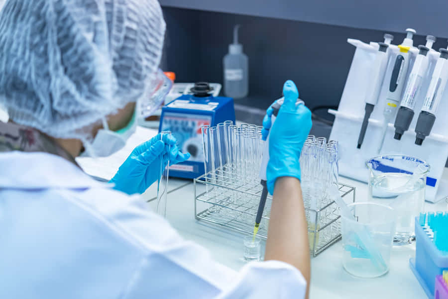 Laboratory Scientist Extracting Liquid Wallpaper