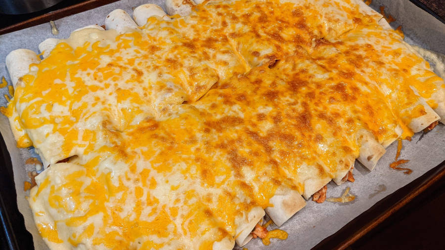 Large Tray Of Cheesy Enchiladas Wallpaper