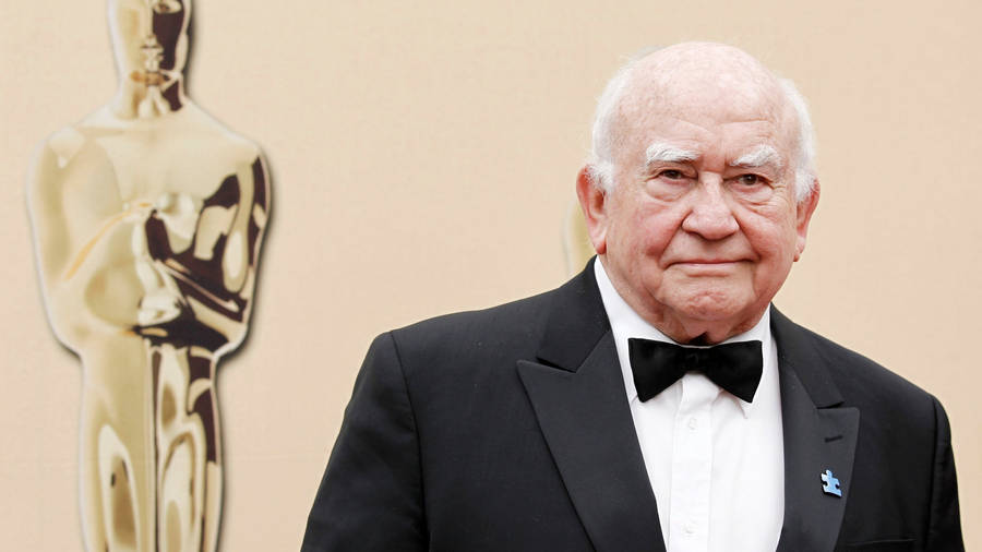 Legendary Actor Edward Asner Holding Golden Trophy Wallpaper