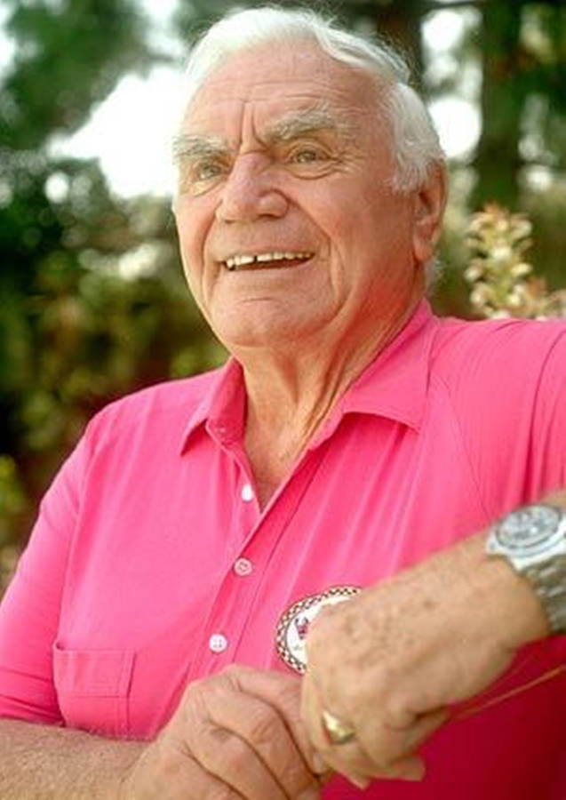 Legendary Actor Ernest Borgnine Smiling In A Pink Shirt Wallpaper