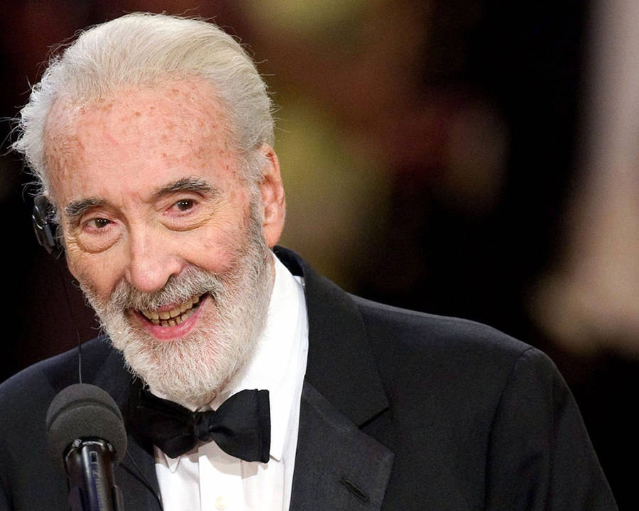 Legendary Christopher Lee At An Award Ceremony Wallpaper