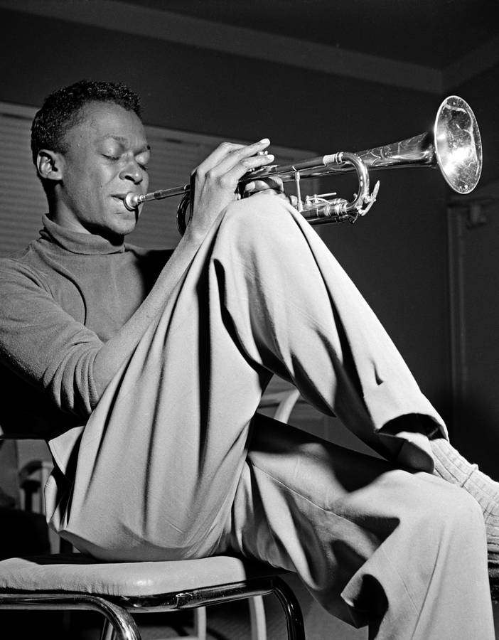 Legendary Jazz Bandleader Miles Davis Performing Wallpaper