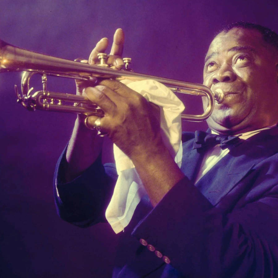 Legendary Jazz Maestro Louis Armstrong In Action Wallpaper