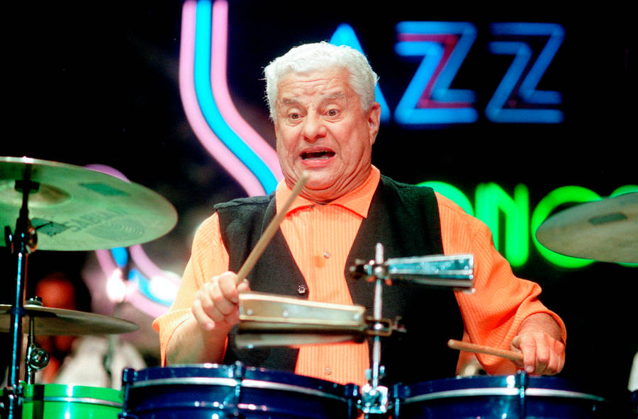 Legendary Latin Music Icon Tito Puente In Action Wallpaper