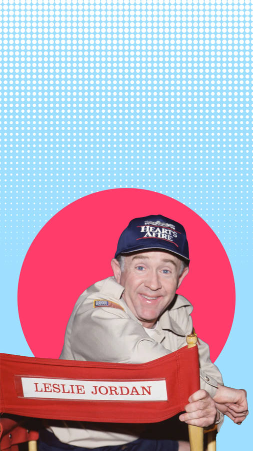 Leslie Jordan Posing In A Red Circle With A Vibrant Blue Background. Wallpaper