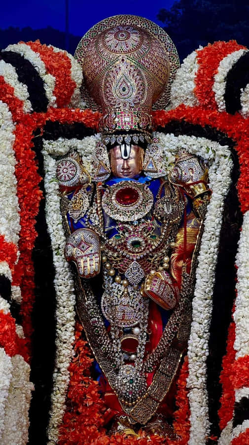 Lord Balaji Adornedin Jewelsand Flowers Wallpaper