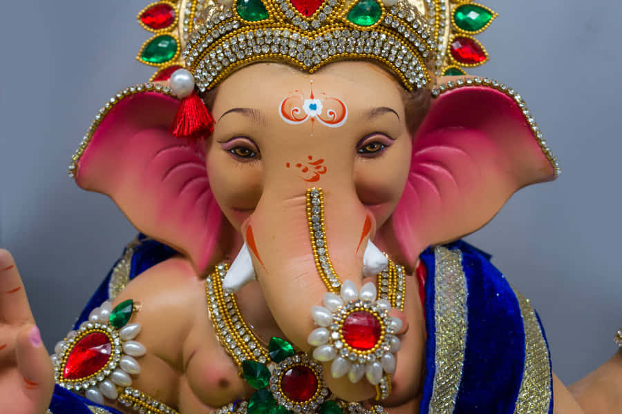 Lord Ganesha Statue Adornedin Jewels Wallpaper