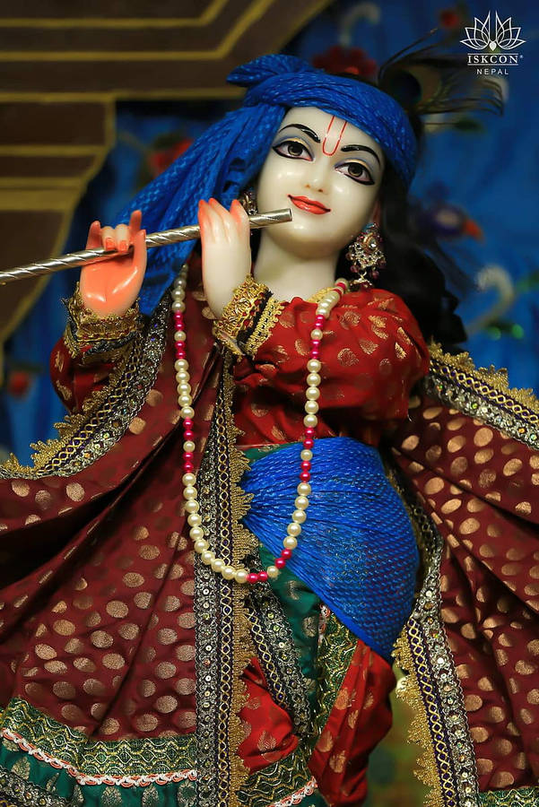 Lord Krishna Adorned In Royal Attire At Iskcon Temple Wallpaper