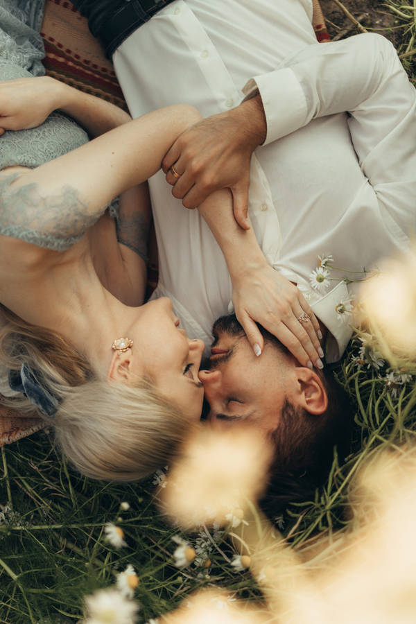 Lovers Lying On Grass Wallpaper