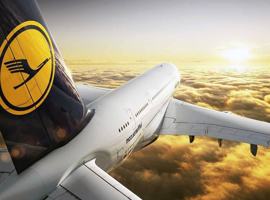 Lufthansa Plane Flying Over Golden Clouds Wallpaper