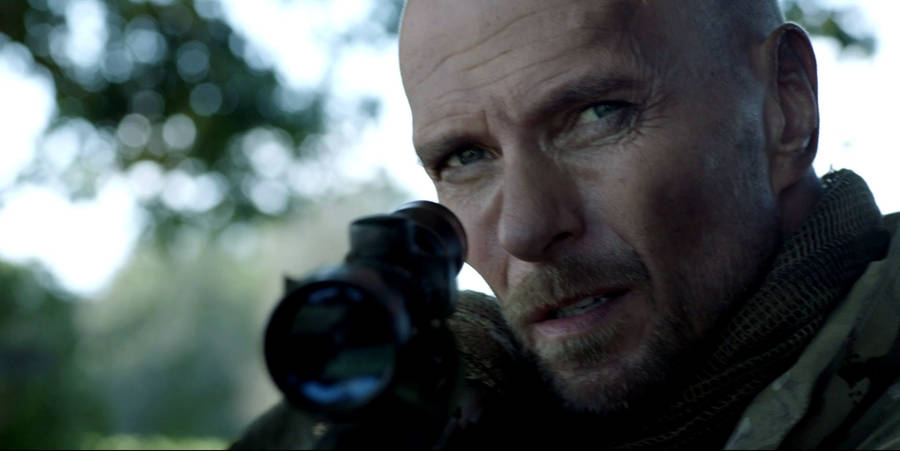 Luke Goss Pointing A Rifle Gun Wallpaper