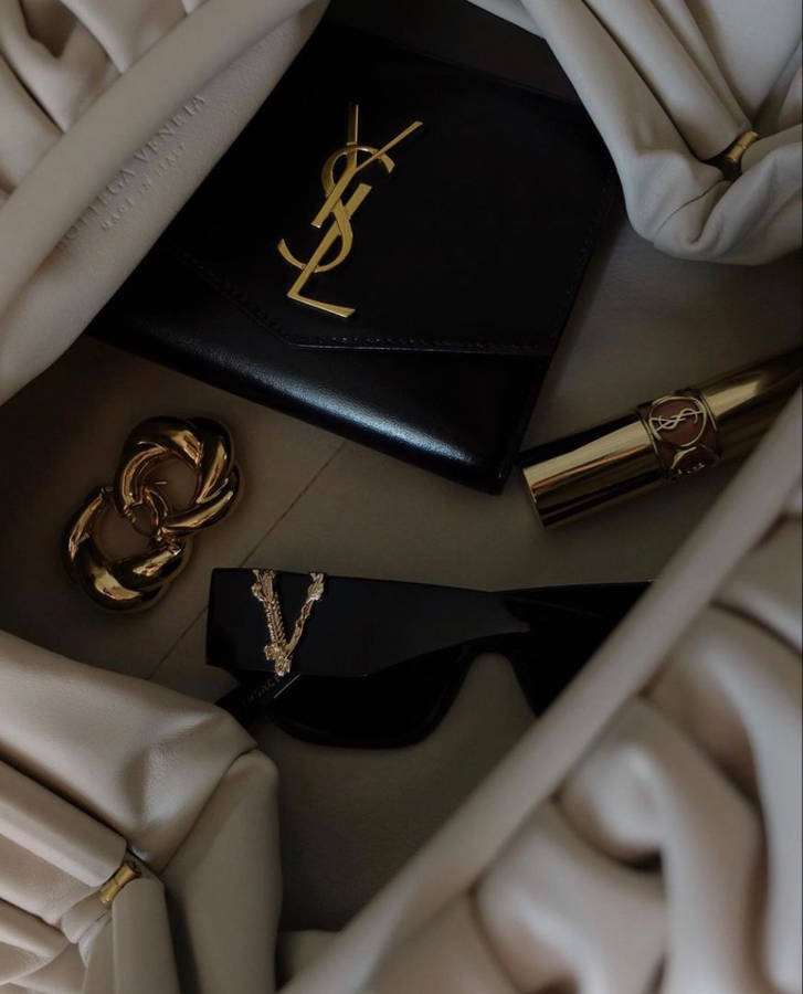 Luxury Items With Ysl Designer Logo Wallpaper