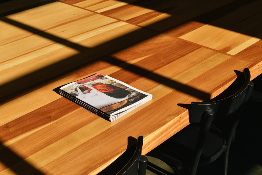 Magazine Placed On Wooden Table Wallpaper