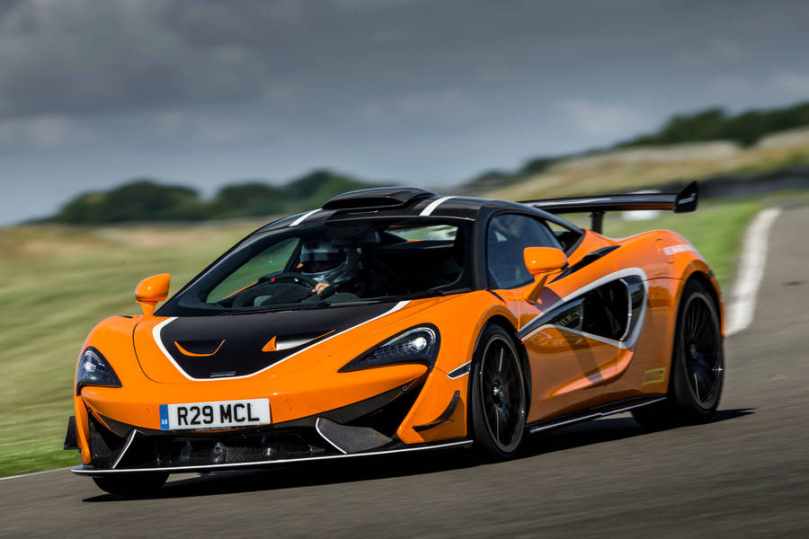 Magnificent Orange Auto Racing Car In Action Wallpaper