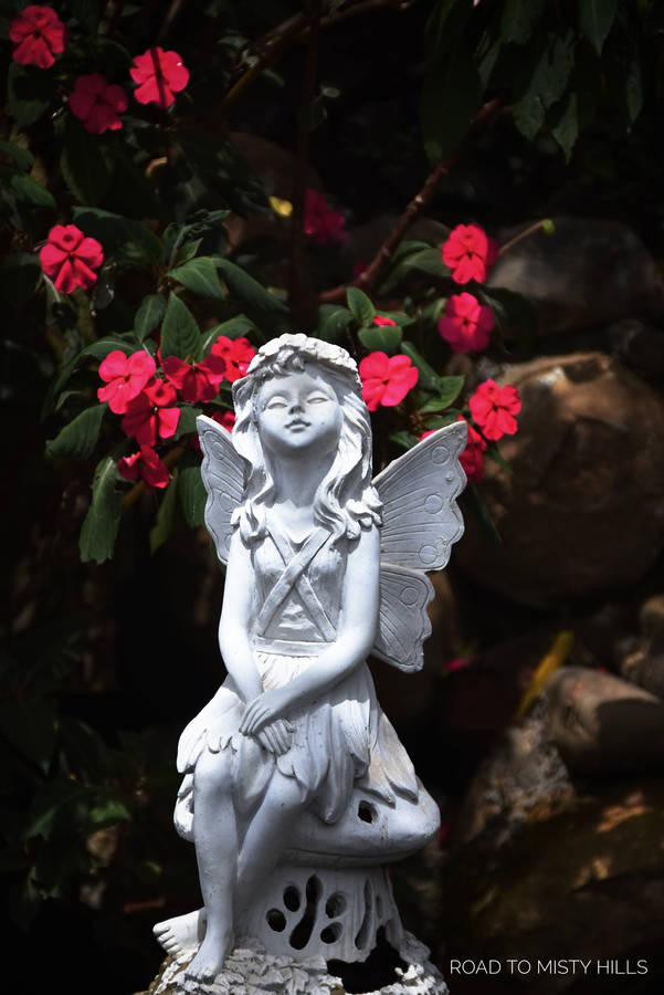 Majestic Angel Statue In Tranquil Setting Wallpaper