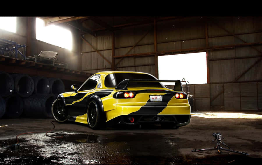 Majestic Black And Yellow Mazda Rx 7 In High Definition Wallpaper