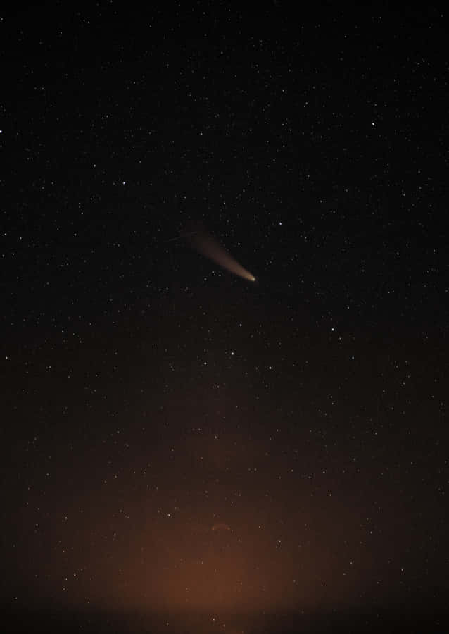 Majestic Comet Traversing The Night Sky Wallpaper