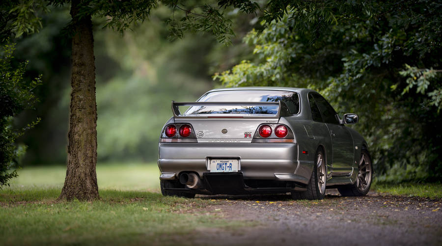 Majestic Dark Grey Nissan Skyline Gt-r R33 In Full Glory Wallpaper