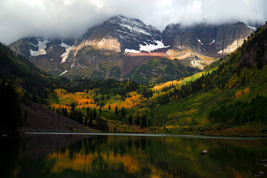 Majestic Fog-covered Peaks At Rocky Mountain National Park Wallpaper