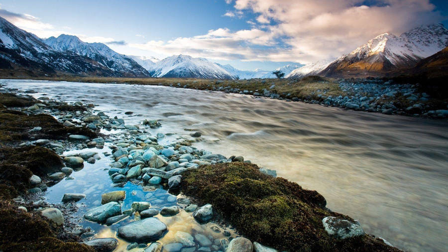 Majestic Mount Aoraki Rising Above The Clouds In New Zealand Wallpaper