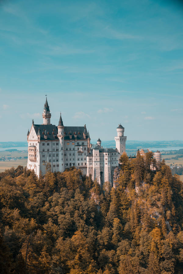 Majestic Neuschwanstein Castle Under Clear Skies Wallpaper