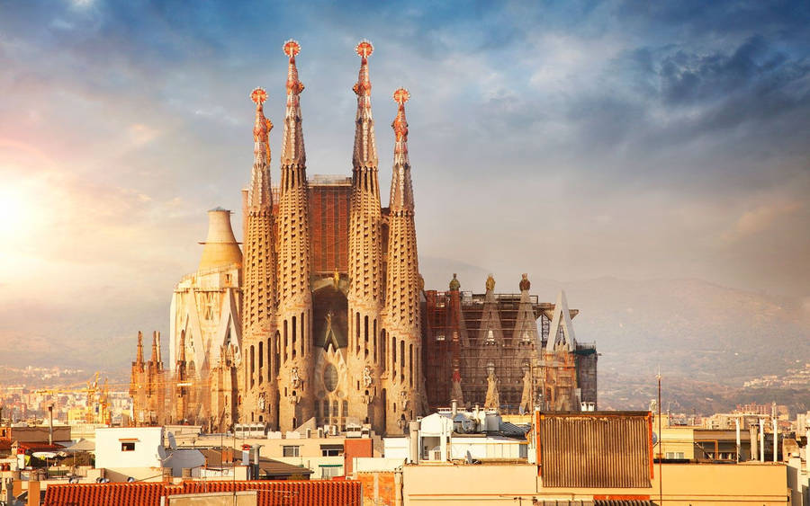 Majestic Sagrada Familia Under The Orange Evening Sky Wallpaper