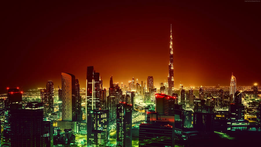 Majestic View Of Dubai Glowing In Red At Night Wallpaper