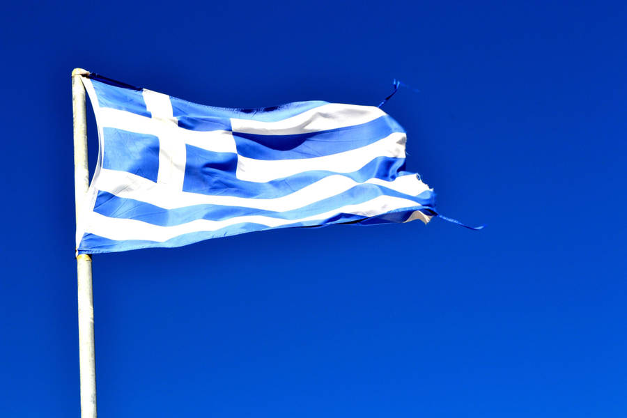 Majestic View Of The Greek Flag Against A Blue Sky Wallpaper