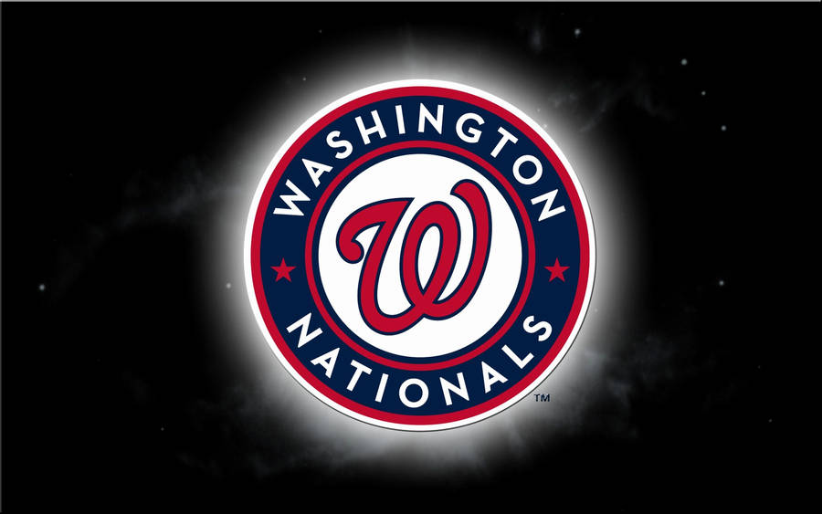 Majestic View Of The Iconic Washington Nationals Logo Shining In The Dark. Wallpaper