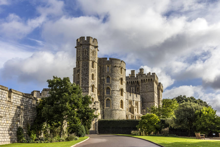 Majestic Windsor Castle Under A Dramatic Cloudy Sky Wallpaper