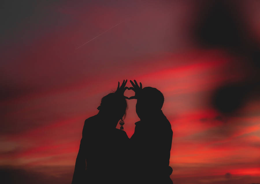 Making A Finger Heart At Sunset Wallpaper