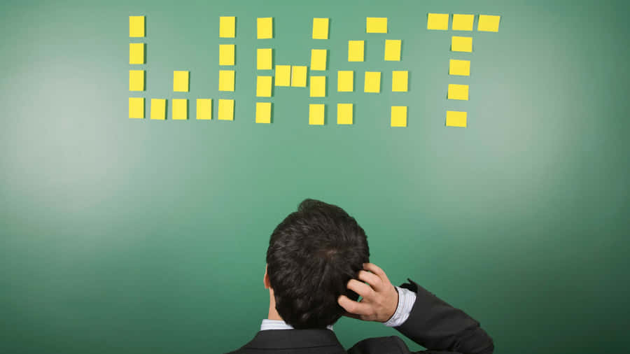 Man Contemplating Task Board Wallpaper