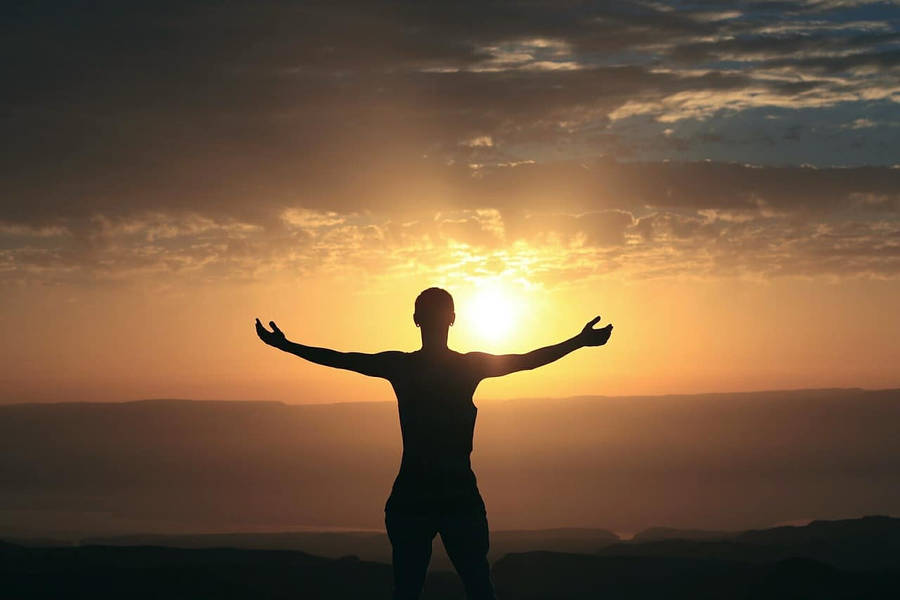 Man Embracing Beauty Of Morning Glory Wallpaper